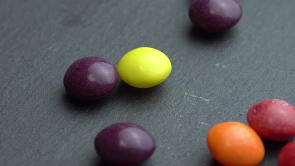 Colored Fruit Sweets Scatter on a Black Background Colored Marco Sweets