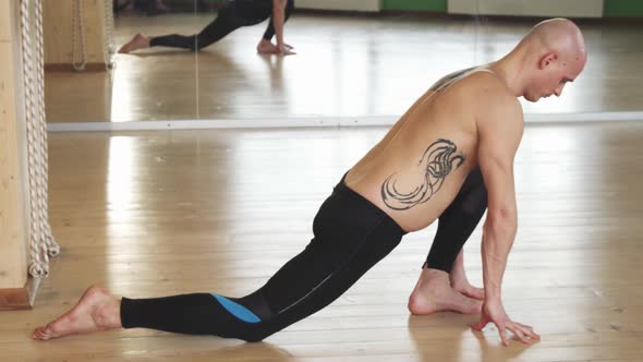 Young Shirtless Man Practicing Yoga Indoors