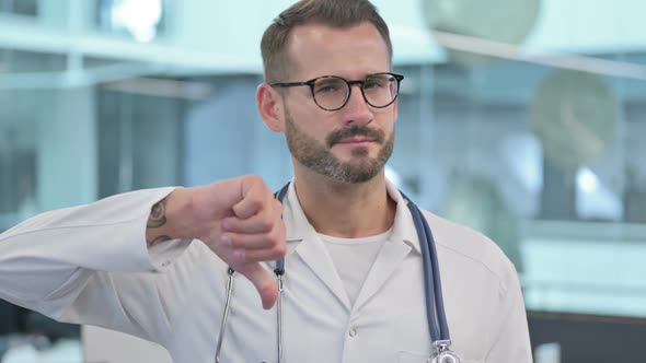 Middle Aged Male Doctor Showing Thumbs Down Sign