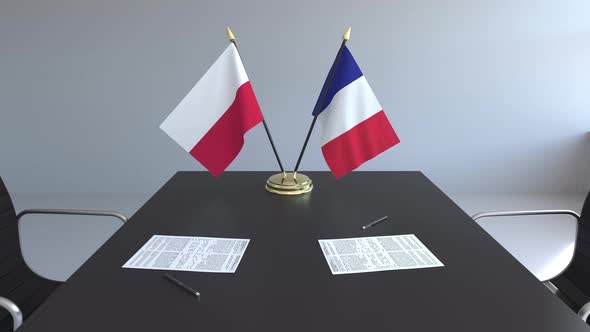 Flags of Poland and France on the Table alt