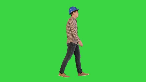 Construction Man in a Hardhat Walking on a Green Screen Chroma Key