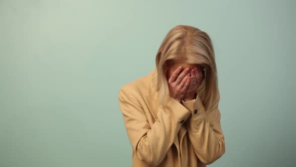 Beautiful woman in jacket laugh on blue background