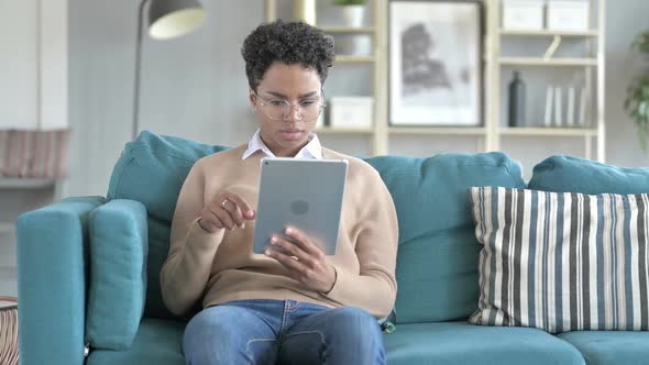 Joyful Smiling African Girl Using Her Tablet