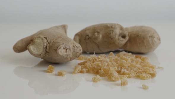 Close-up of sweet candied ginger root pile 4K 2160p 30fps UltraHD tilting footage - Cubes of crystal