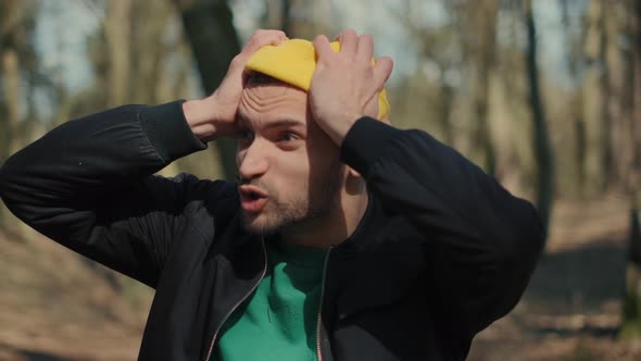 A Sad Man Is Sitting Alone on the Ground By a Tree, Suffering Emotional Pain and Thinling About