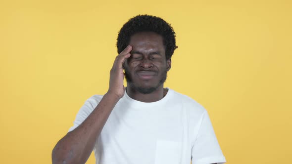 African Man with Headache Yellow Background