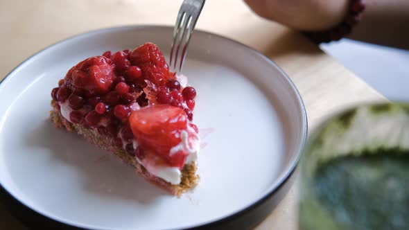 Closeup of Female Hand Breaking Off Piece of Cake