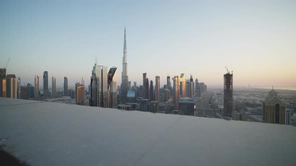 Reveal of Urban City Center of Dubai with Burj Khalifa During Sunset