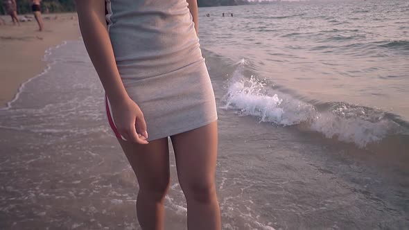 Brunette Girl in Short Dress Walks in Surf Line Slow Motion