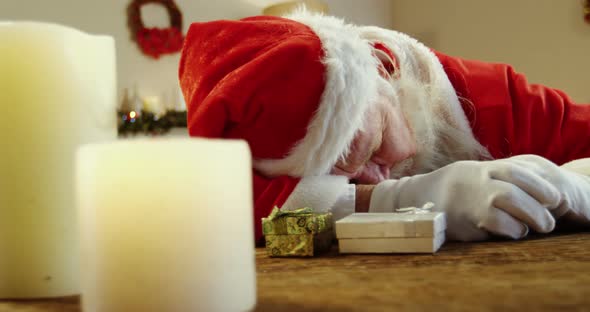 Santa claus sleeping at desk