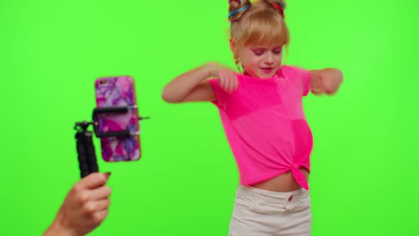 Dancing Young Little Kid Girl Blogger Record Dance Moves at Camera for Social Media Content on Phone