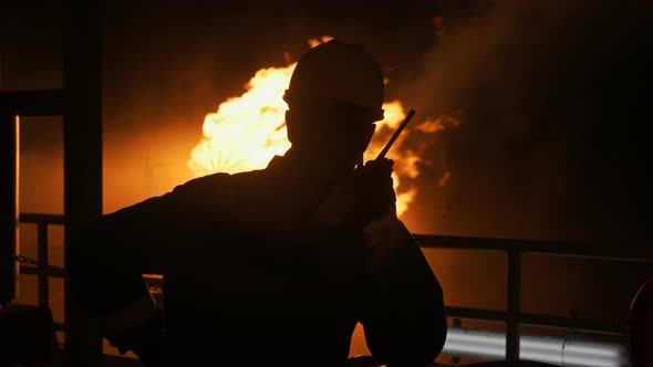 Silhouette of a Man Against a Flame