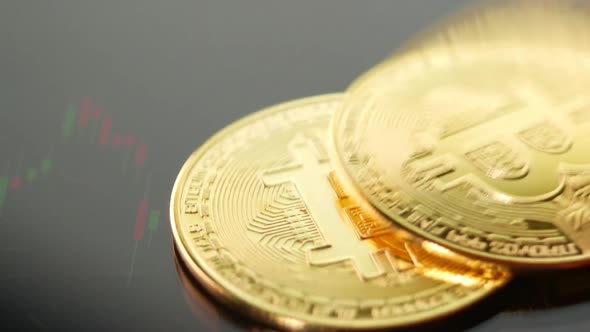 Golden coins with bitcoin symbol on market price chart