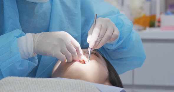 Dentist examines the patient teeth