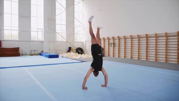 A Sportsman Is Doing a Cartwheel and a Double Back Flip and Lands, Steadicam.