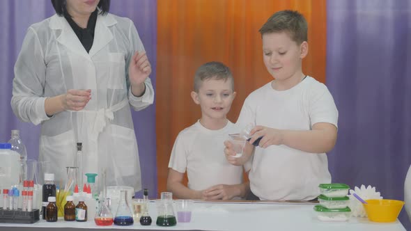 Chemical Experiments for Children. Fun Experiments for Children. Woman Makes Magic Movements with