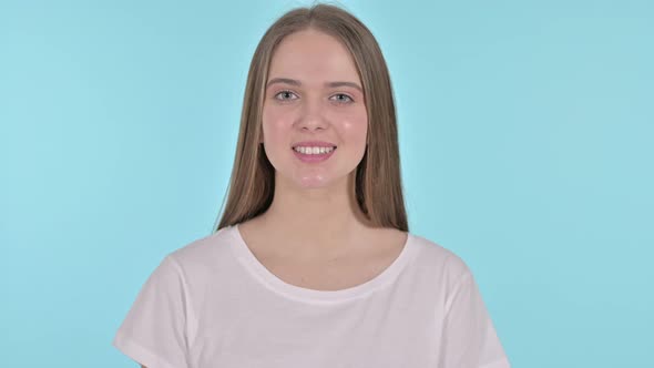 Flying Kiss By Beautiful Young Woman, Blue Background