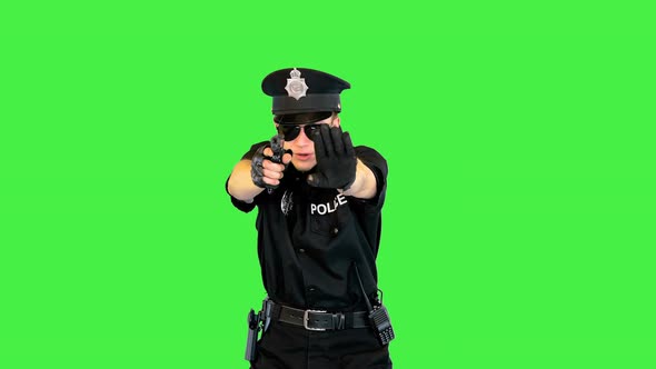 White Policeman Stands Gets the Gun Out Aims and Puts It Back on a Green Screen Chroma Key