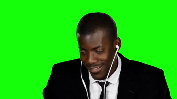 Happy Businessman Listening To Music. Green Screen