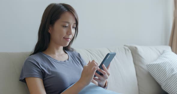 Young woman use of mobile phone at home