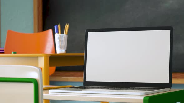 Modern laptop with white blank screen placed on desk against classroom at school. 3d animation