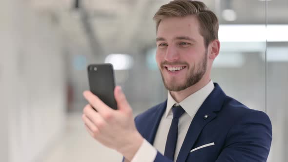 Young Businessman Making Video Call on Smartphone