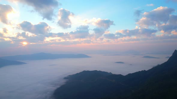 Flying over the clouds during morning sunrise