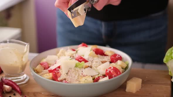 Cooking Caesar Salad Inside Deep Cooking Bowl  Slicing Parmesan Cheese