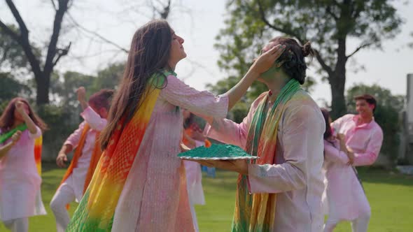 Indian people playing Holi and dancing