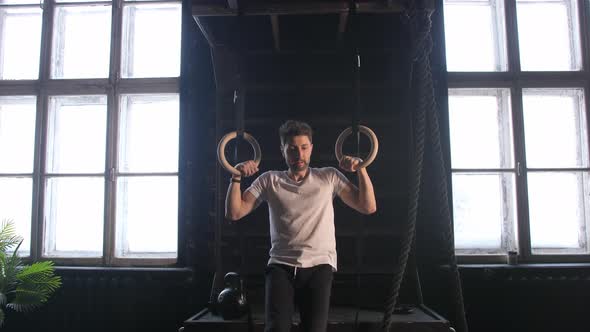 Man Doing Pull Ups on the Rings