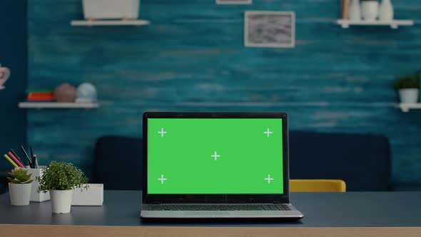 Green Screen on Modern Laptop Computer in Living Room