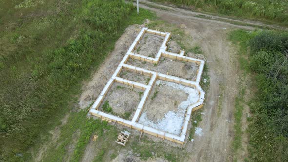 Aerial view of building works of new house concrete foundation on construction site.