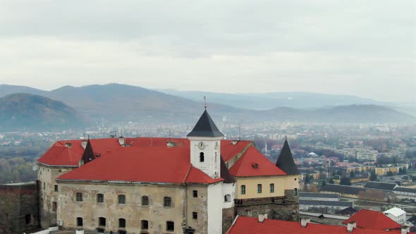 Aerial View on the Ancient Castle of Palanok and the Foothills of Carpathians Mountains, in