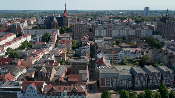 Forwards and Tilt Down Reveal of Buildings in Town