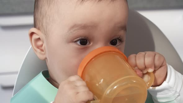 1-Year-Old Baby Drinking from Beaker Cup