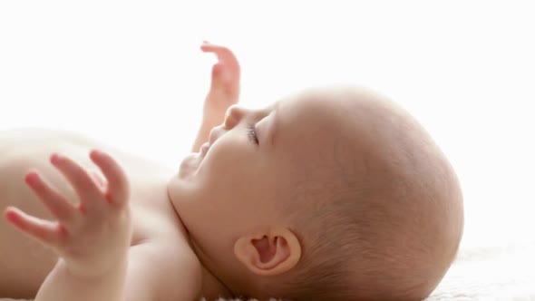 Baby Boy Lying on Back, Side View