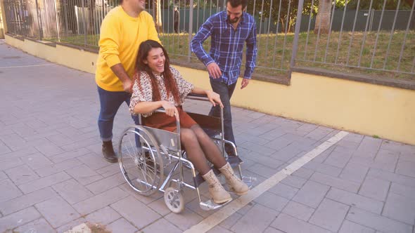 fun, friendship - young woman with paraplegia have fun with her funny friends