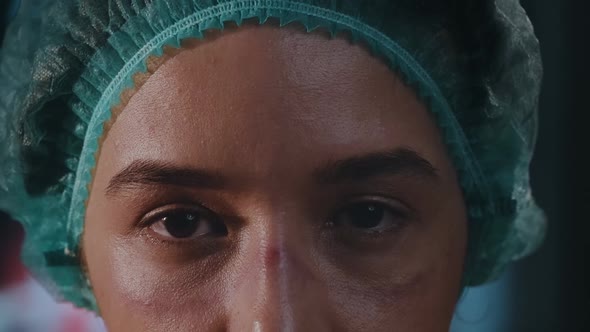 Woman doctor on her face marks are visible from protective mask, red spots