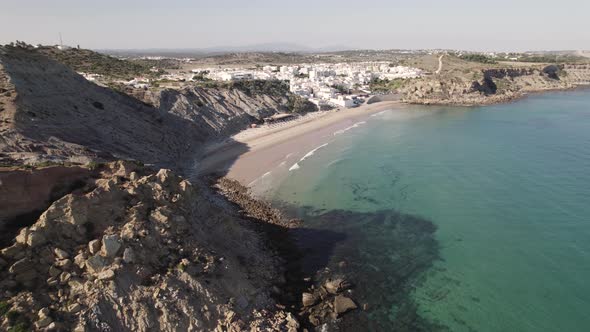 Aerial view of old coastal fishing village whitewashed cottages houses in Burgau