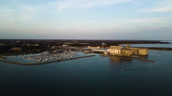 Aerial view of a motorboat driving past a marina and port facilities on Lake Erie.