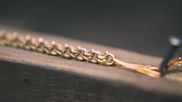 Goldsmith Polishes Chain with Rasp on Wooden Part Close View