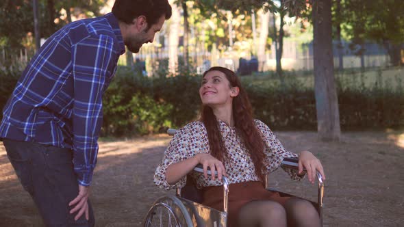 solidarity, affection - man invites his friend with paraplegia for a walk