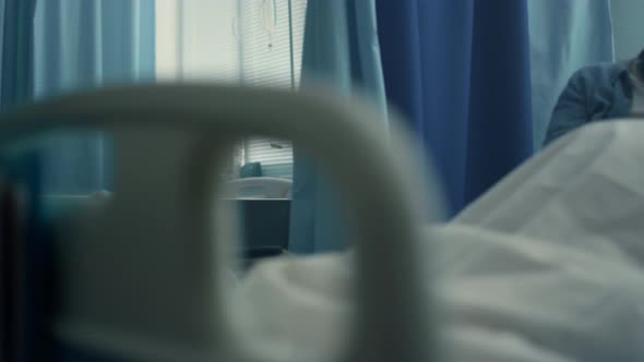 Smiling Mom Visiting Daughter Play on Tablet Computer Together in Hospital Room