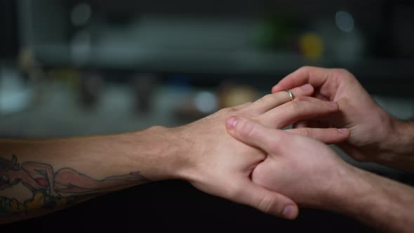 Closeup Hand of Gay Man with Loving Boyfriend Putting on Engagement Ring