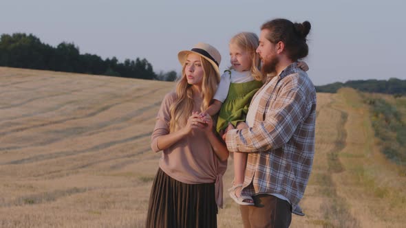 Caucasian Farmers Family Stands in Wheat Field Looks at Horizon Rural Nature Landscape