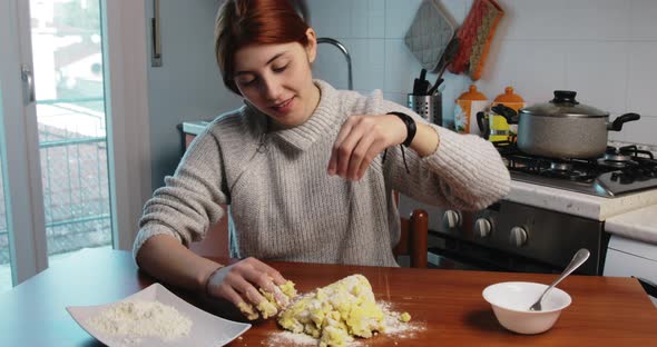 Girl is Putting Flour Into Potato Dough for Homemade Gnocchi