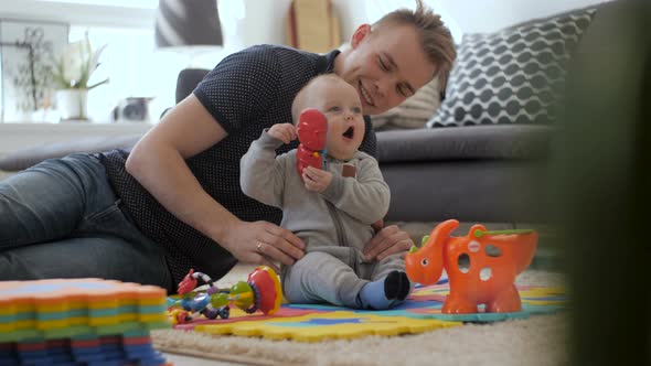 Father And  Baby Son Playing And Home