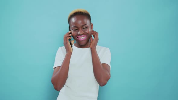 Afro American Woman Talking on Phone Over Blue Background