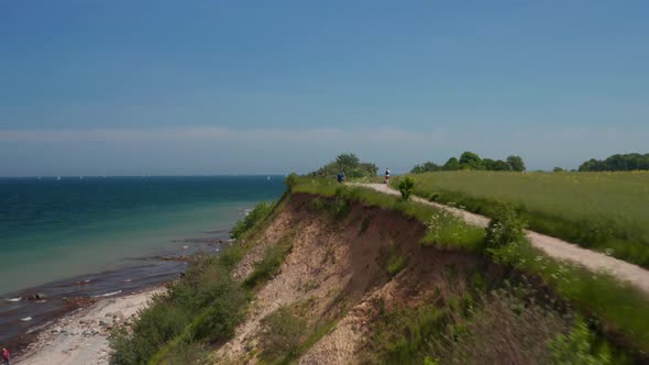 Peaceful Coastline Scenery Aerial Drone Flying Above Foot Walk Path with Blue Turquoise Baltic Sea