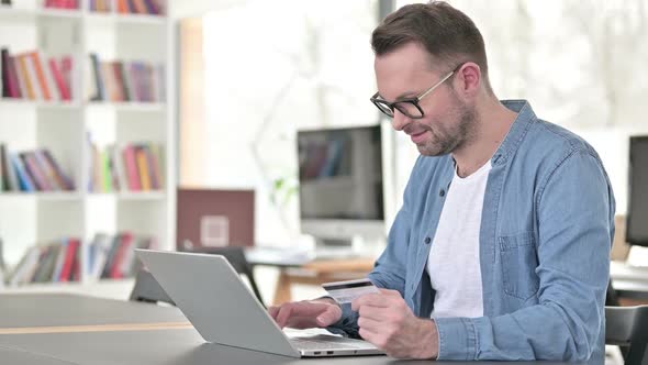 Successful Online Shopping By Young Man on Laptop